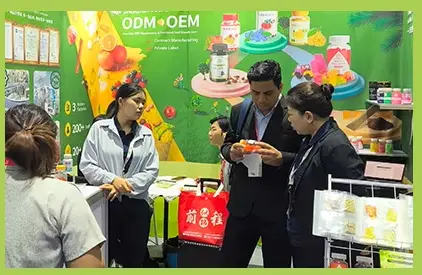 MITEYO team reviewing supplement samples with buyers at an exhibition
